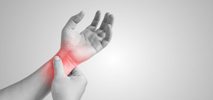 Pain in her wrist, isolated in a white background. Red circle around the painful area.